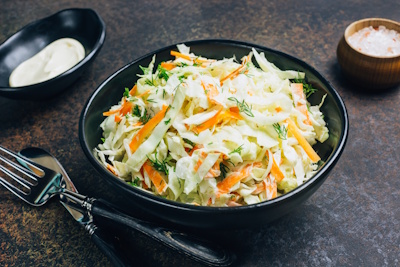 Traditional cole slaw salad in a black bowl. Fresh cabbage and carrot salad with mayonnaise. Dark background. Selective focus SSUCv3H4sIAAAAAAAEAJ2RTW7DIBCF95V6B4t1LJmY4iZXiboYA7FRCESAW1lR7l4wppp1d8z3mJ8383x/axoyQtCCnJtnjlKsjVlC9BC1swl3h517ZaXymCipo/MaDIYjRDFbuKsE7WJMxq9NJCFCXIIKudmOBEQ1pRoF/pUoE11K3FRhE1NGkgg5IBaWcWMVvQ7/ziyPr+oGJmXFug2MjHhlFBQjl/KV3H6i8ndsDRapHXL17QSY/KFHlR5eC20nlObivG25pgm32OhXPDkxzj1gNHnF11RTVT5DCOm7rBw1Eumm7o76WBc3A3tVItMlckj7Y0cZOw6c04EOHeWkXs+Jm5bYYjnorJPkV8R1noAwxjkT3Ud7Yoy2jPas/RRqaMdO8mHg3bU/QVr86xfkW0aZhwIAAA==